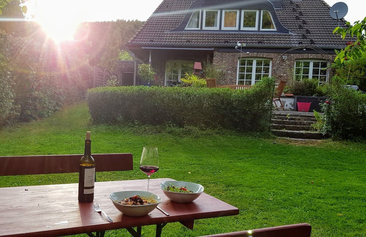WaldBachHouse exterior at sunset with garden benches